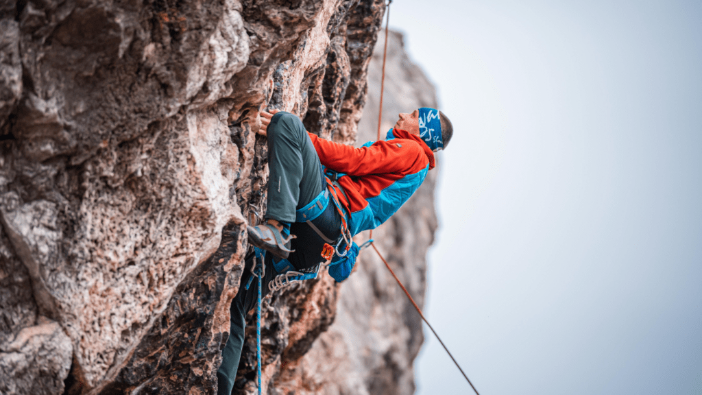 a person is climbing on a rock in the woods