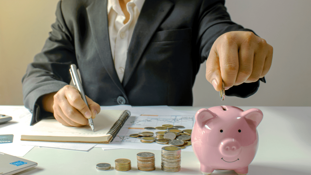 a person putting a coins in a piggy bank