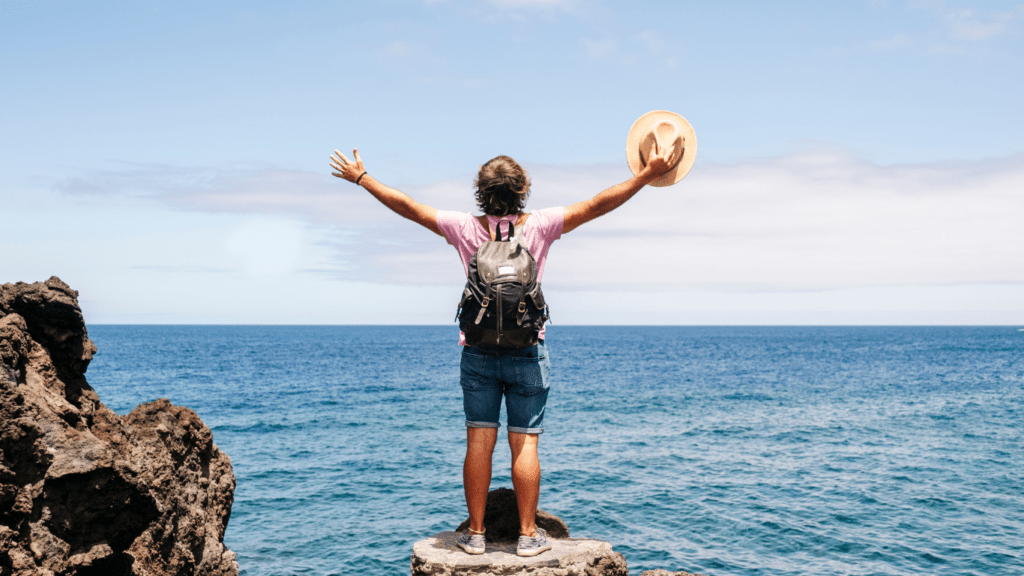 male tourist standing on rock