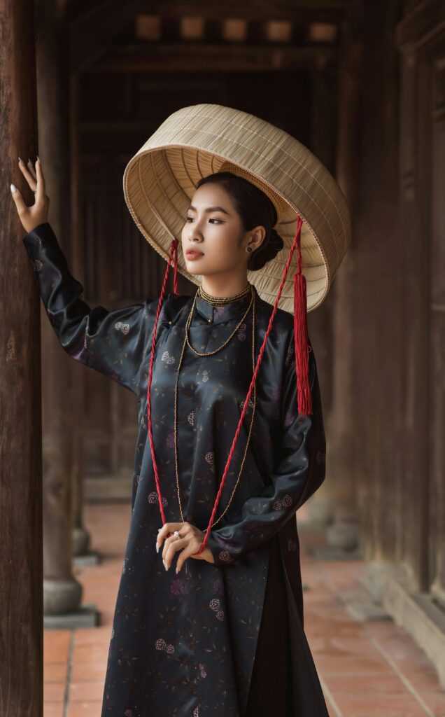 Elegant woman in traditional Vietnamese attire, Hội An setting.